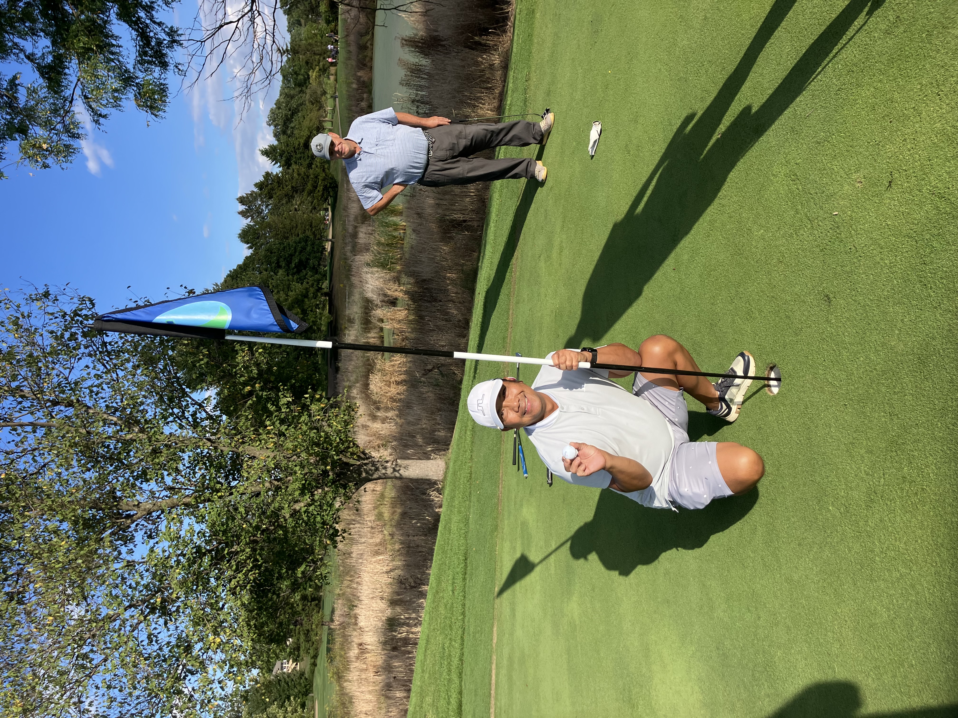 A golfer celebrating on the green